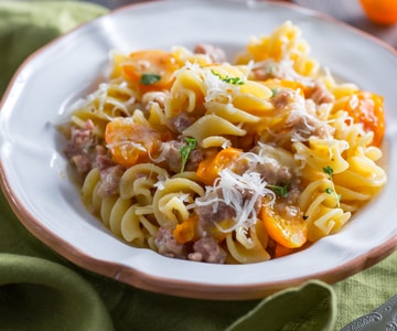 Fusilloni with sausage, yellow cherry tomatoes, and provolone