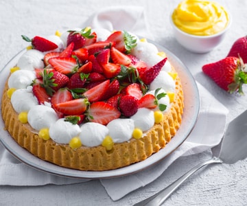 Soft tart with cream, whipped cream, and strawberries