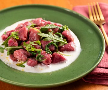 Beetroot dumplings on taleggio fondue