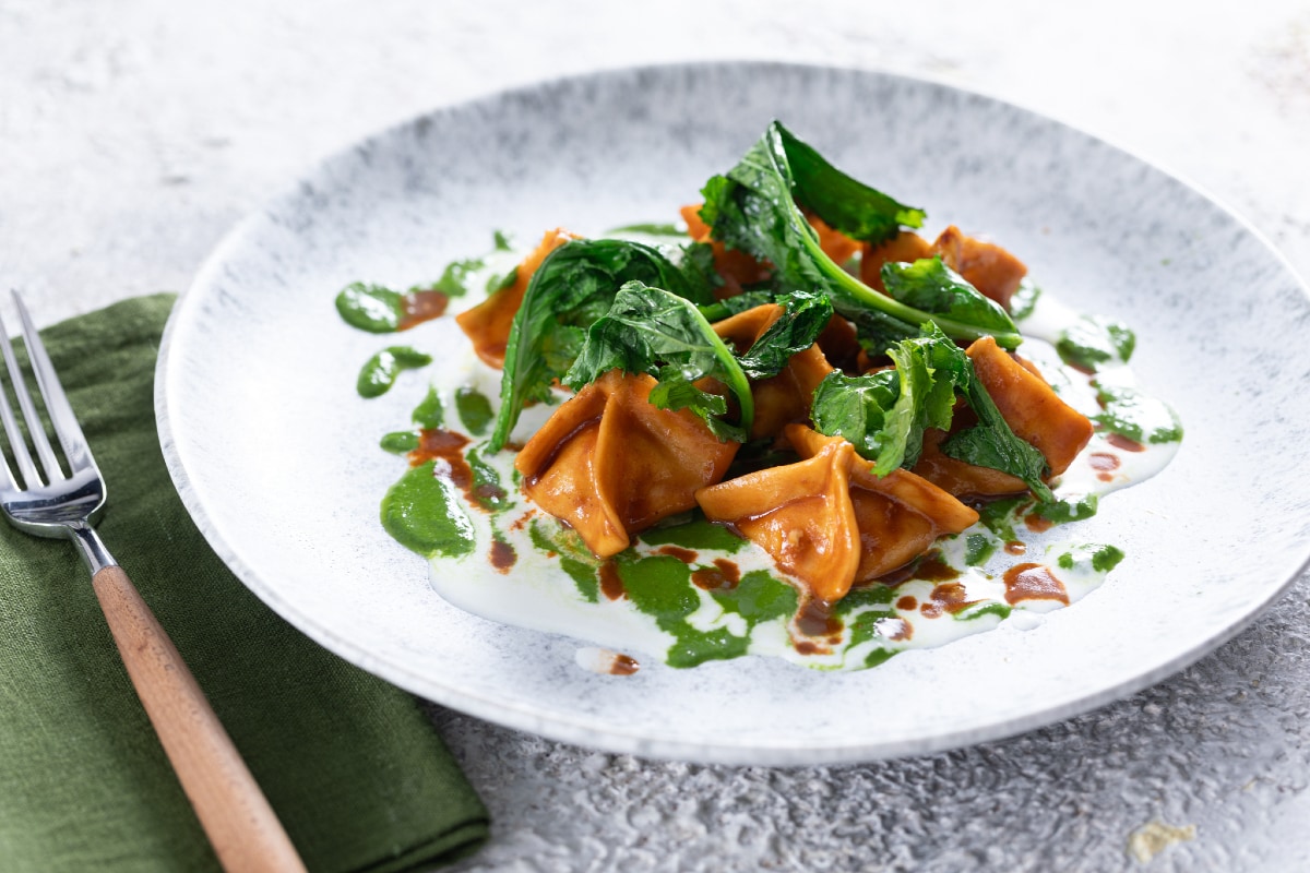 Shrimp ravioli with stracciatella and turnip greens